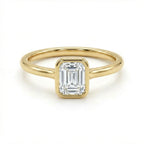 Solid 14K yellow gold emerald cut diamond ring with bezel set center stone and sleek band