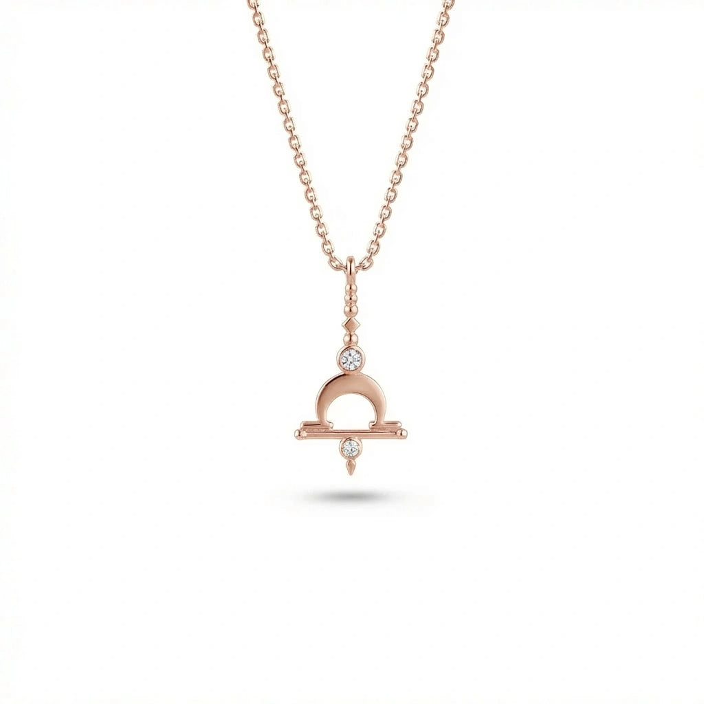 Aurex Libra Zodiac Diamond Necklace in 14K rose gold, front view showing Libra scales symbol with crescent arch, horizontal bar, and twin lab-grown diamonds on cable chain