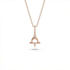 Aurex Libra Zodiac Diamond Necklace in 14K rose gold, front view showing Libra scales symbol with crescent arch, horizontal bar, and twin lab-grown diamonds on cable chain