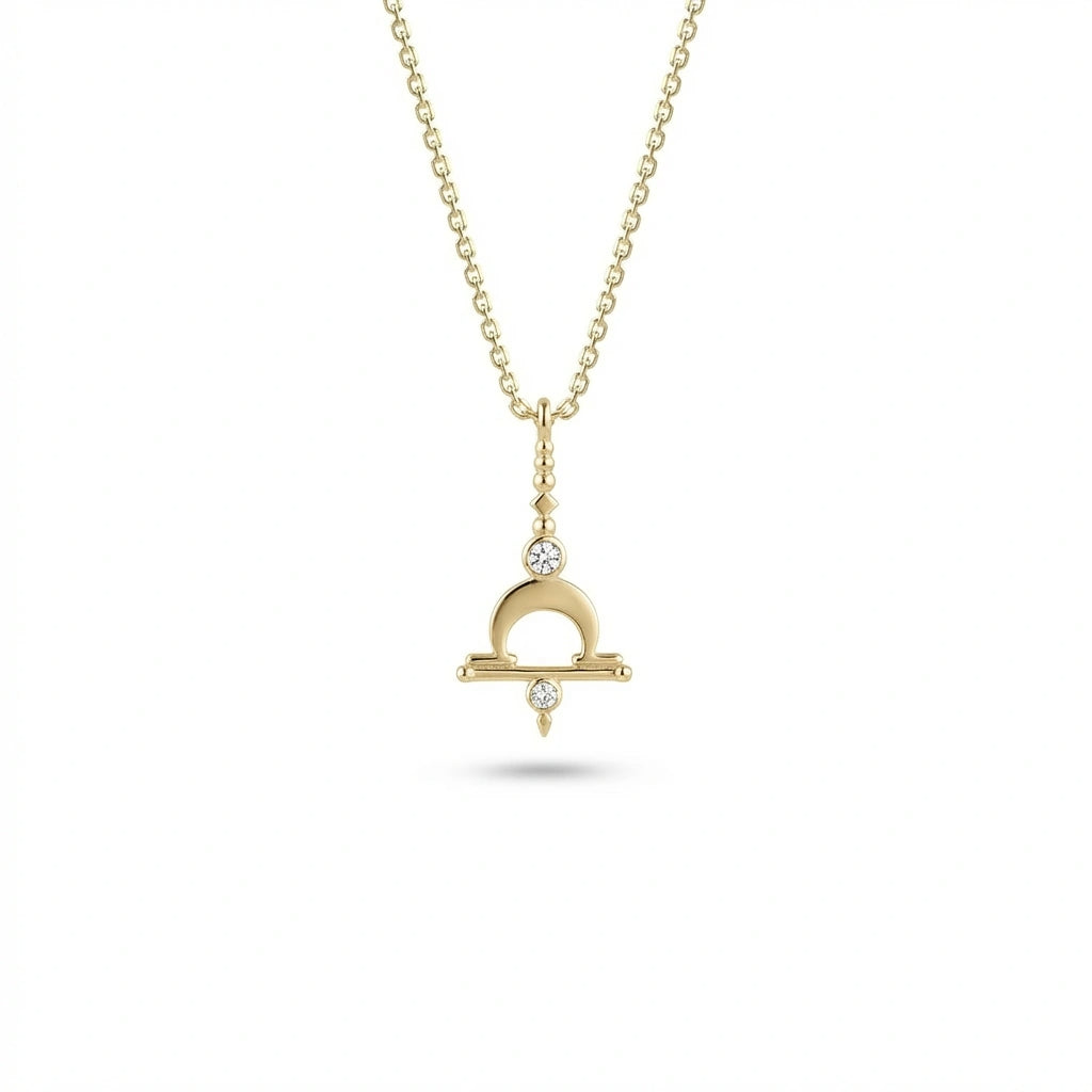 Aurex Libra Zodiac Diamond Necklace in 14K yellow gold, front view showing Libra scales symbol with crescent arch, horizontal bar, and twin lab-grown diamonds on cable chain