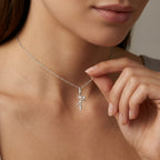 Model wearing Aurex Sagittarius Zodiac Diamond Necklace in 14K white gold at décolletage, close-up editorial shot showing diagonal arrow glyph with three cascading diamonds