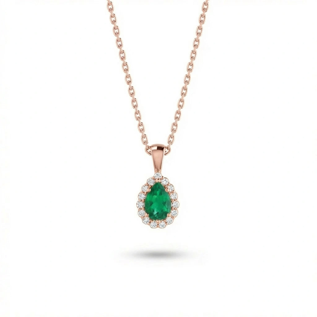 Aveline emerald halo pendant in solid rose gold featuring pear shape green emerald center stone surrounded by round diamond halo
