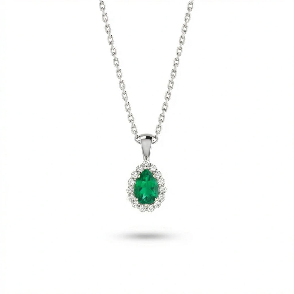 Aveline emerald halo pendant in solid white gold with pear cut emerald centerpiece and diamond halo setting