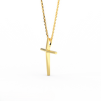 Angle view of 14K yellow gold minimal cross pendant showing tapered thickness