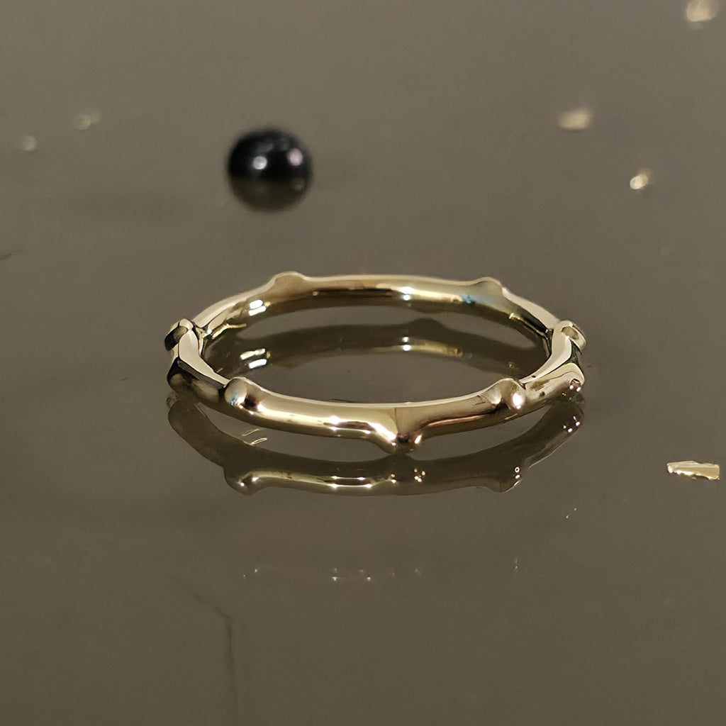 Close-up of organic bamboo-inspired 14K gold ring, nature-inspired band