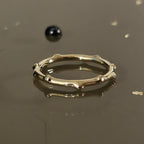 Close-up of organic bamboo-inspired 14K gold ring, nature-inspired band