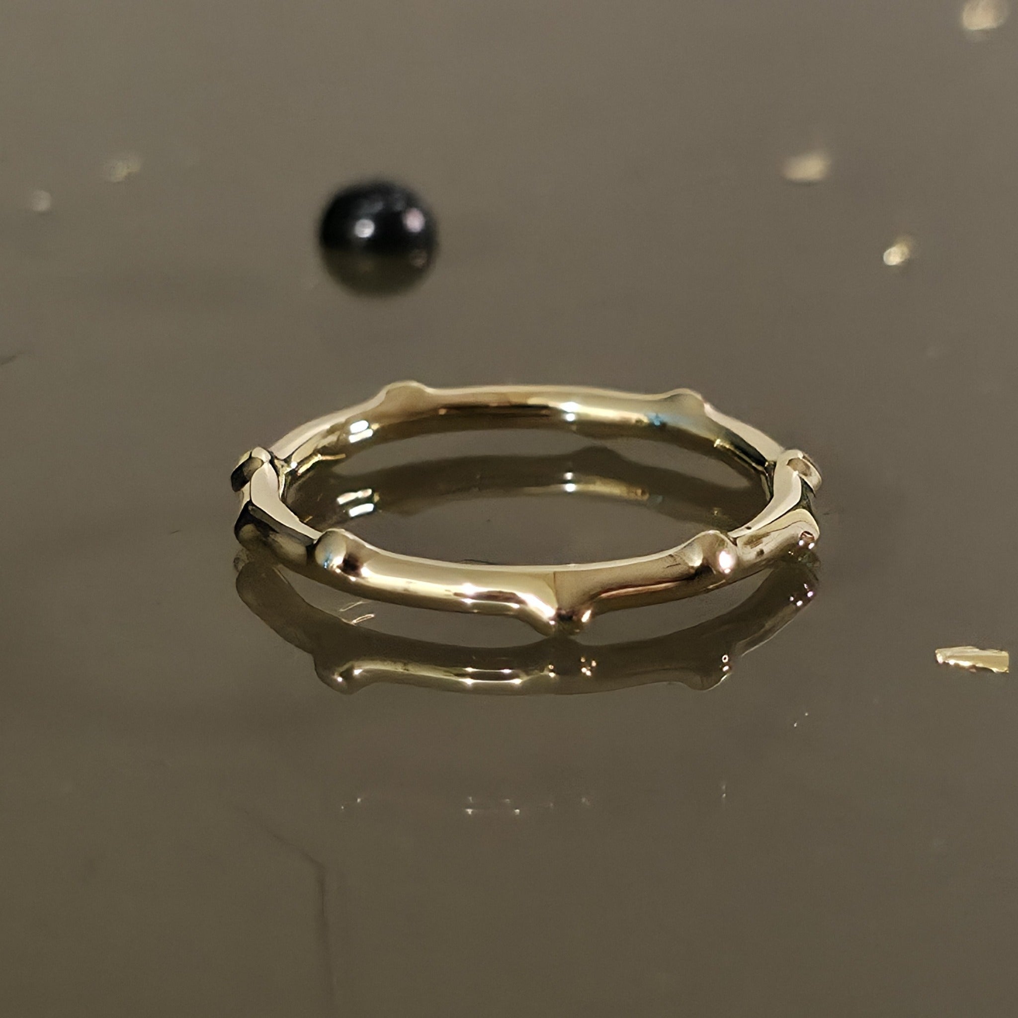 Close-up of organic bamboo-inspired 14K gold ring, nature-inspired band