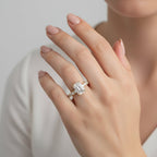 1ct emerald cut engagement ring set north south with diamond pavé band worn on hand
