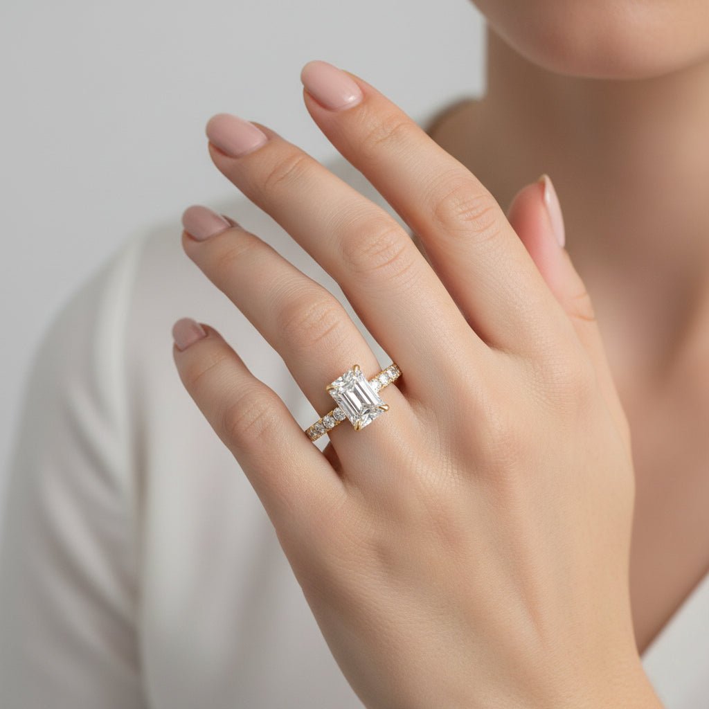 1ct emerald cut engagement ring set north south with diamond pavé band worn on hand