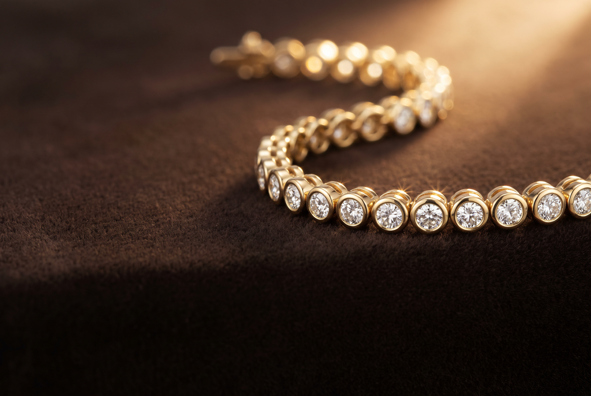 Bezel-set lab-grown diamond tennis bracelet in 14K yellow gold on dark velvet