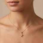 Model wearing a 14K yellow gold starfish necklace on an adjustable cable chain — Black Pearl of Queens