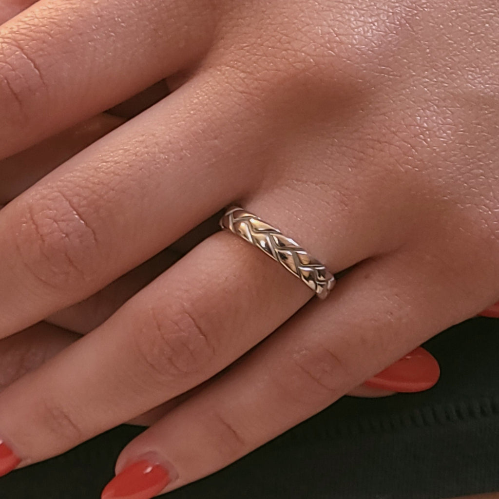 Braided 14K gold band worn on hand showing woven texture and slim profile
