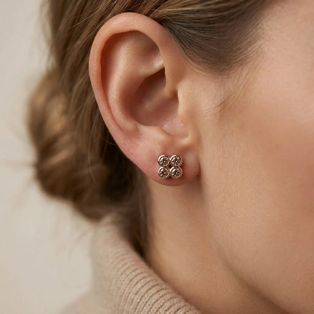 Natural cognac diamond clover stud earrings in 14K brown gold worn on ear — close-up side view, Brownstone Collection by Black Pearl of Queens