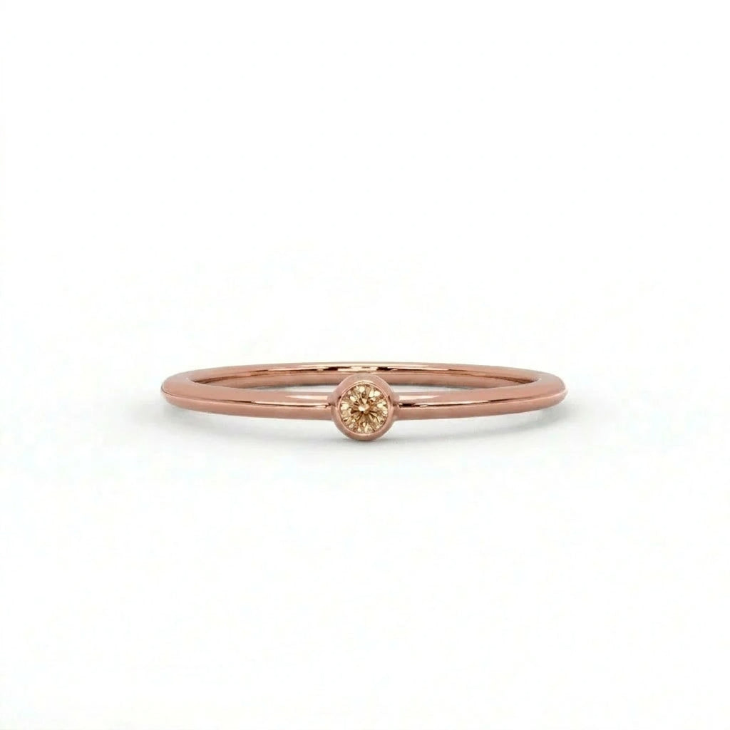 Natural champagne diamond bezel-set stacking ring in 14K rose gold, front view — Black Pearl of Queens