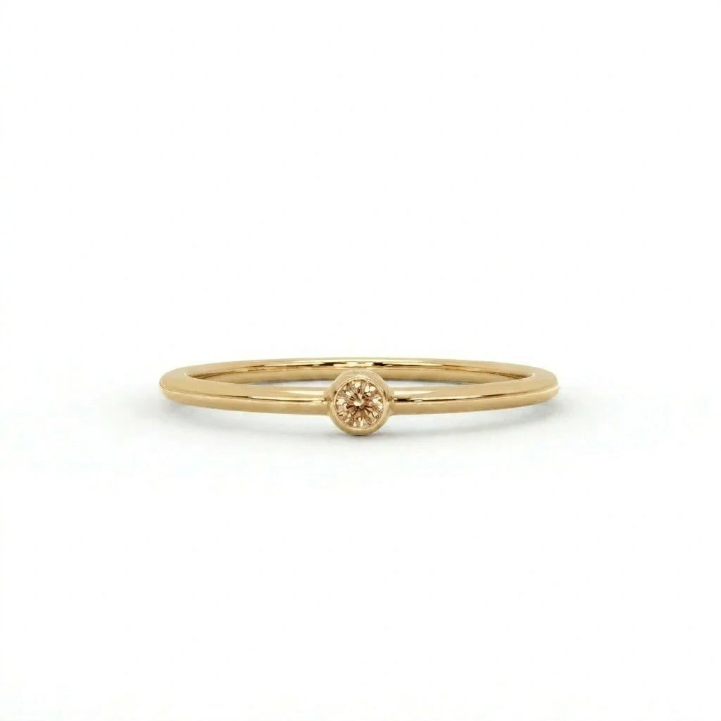 Natural champagne diamond bezel-set stacking ring in 14K yellow gold, front view — Black Pearl of Queens
