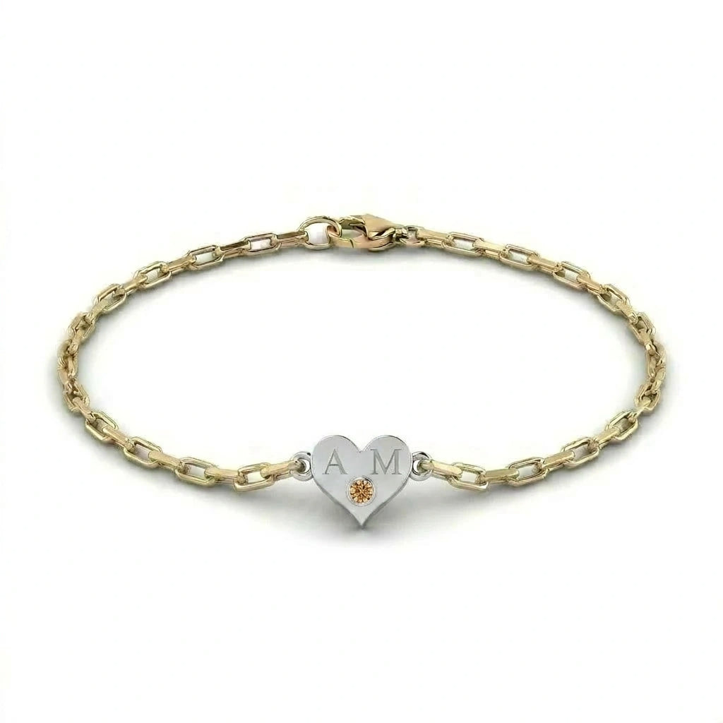 Brownstone champagne diamond heart bracelet in 14K white gold with engraved initials on yellow gold paper clip chain — product view on white background