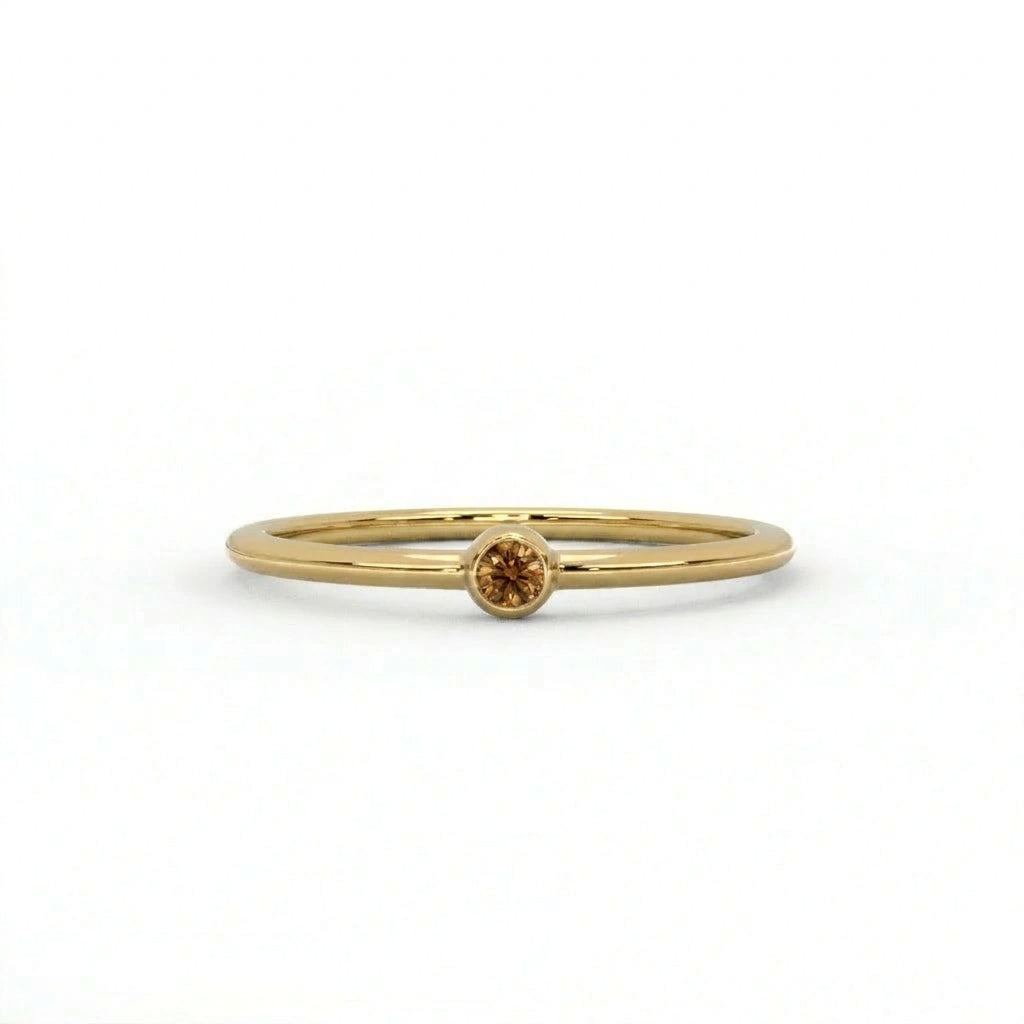 Natural cognac diamond bezel-set stacking ring in 14K yellow gold, front view — Black Pearl of Queens
