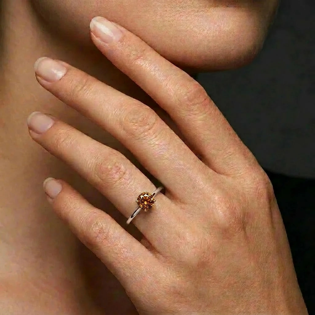 Cognac diamond solitaire engagement ring worn on hand — Black Pearl of Queens