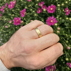 Brushed gold wedding band in 14K on hand outdoors, 6mm comfort fit ring by Black Pearl of Queens