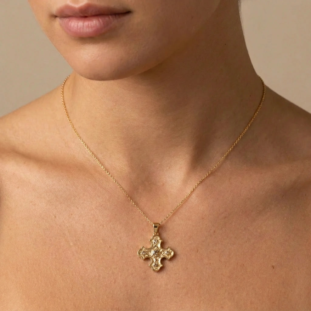 Natural champagne diamond Byzantine cross pendant in 14K yellow gold worn on neckline — Brownstone Collection by Black Pearl of Queens, handcrafted in NYC