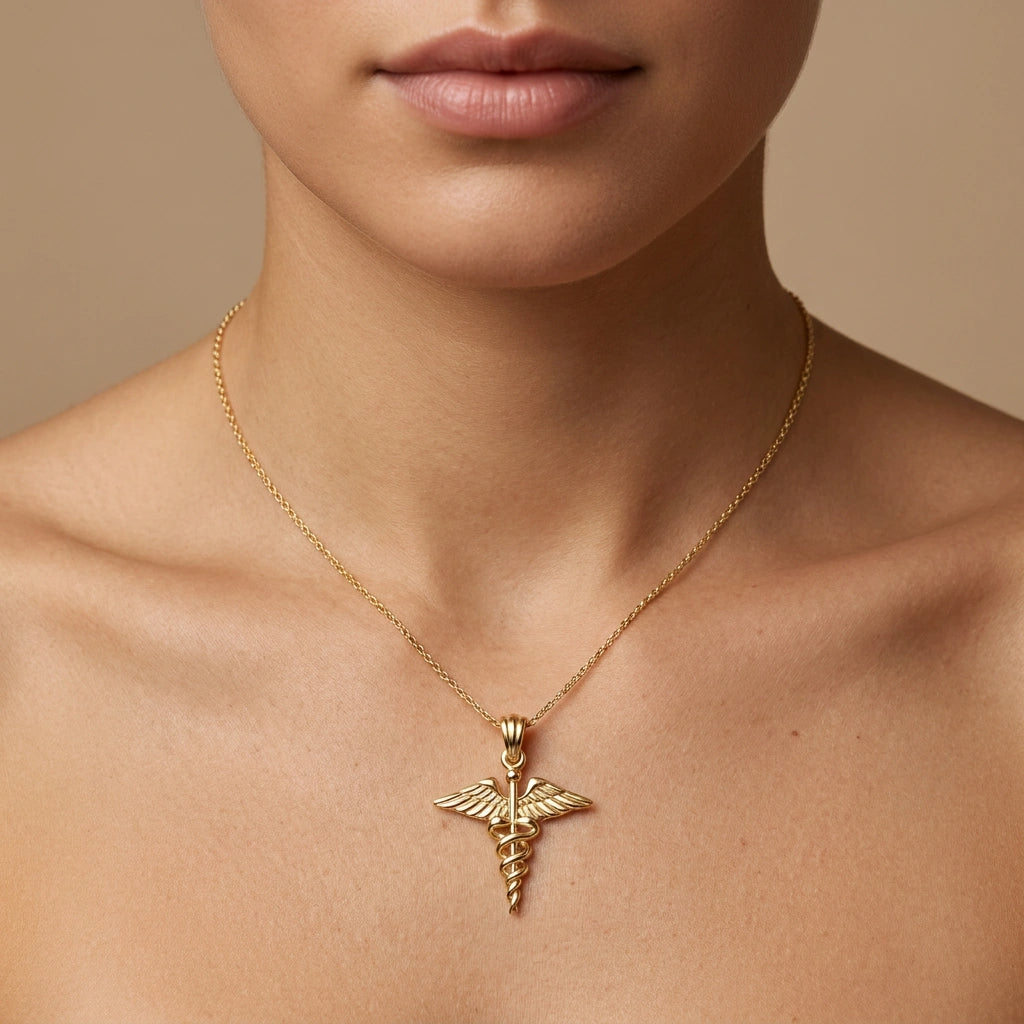 14K yellow gold caduceus medical pendant worn on model — Black Pearl of Queens