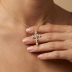 Woman wearing celestial diamond cluster cross pendant - elegant lifestyle photo showing sparkle