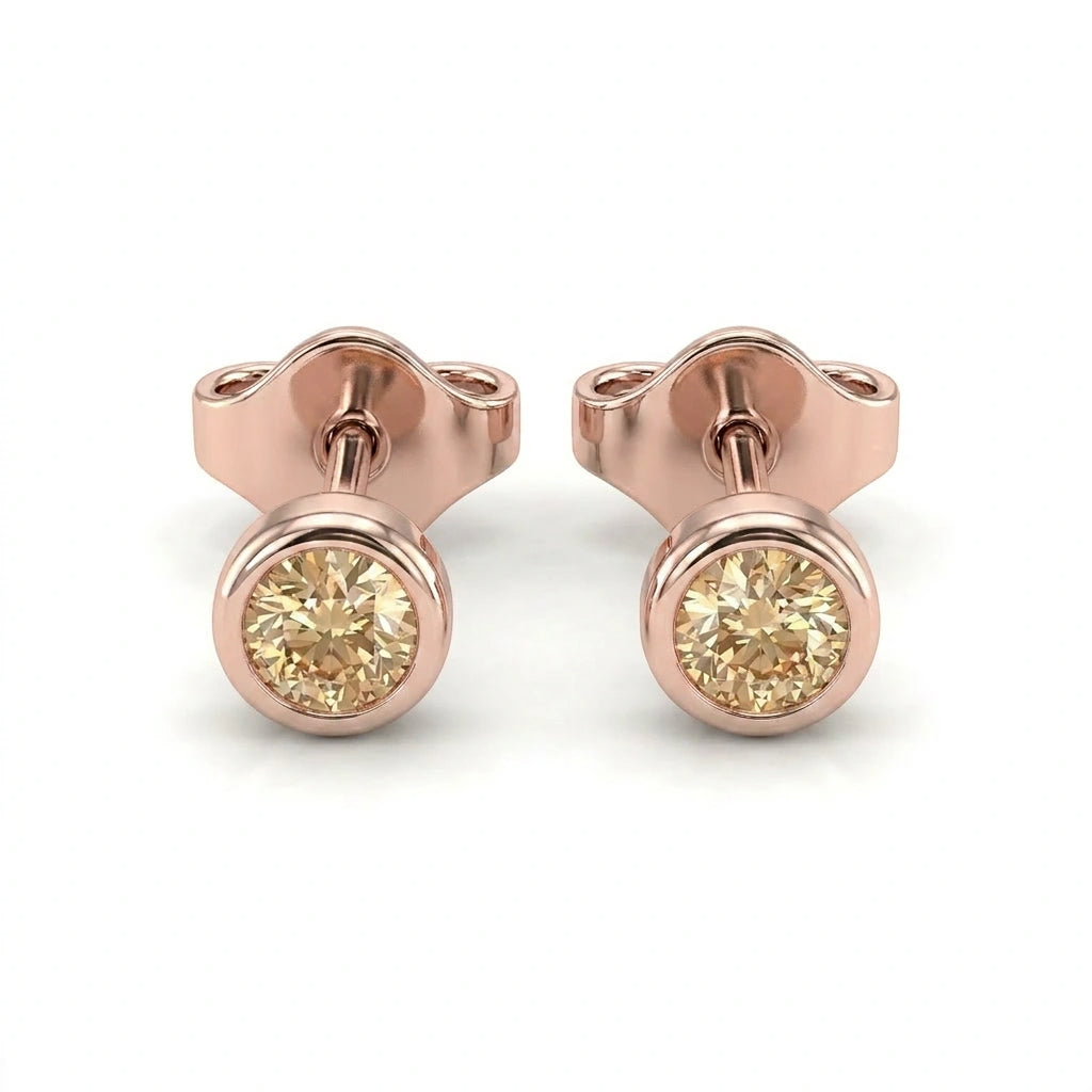 Natural champagne diamond bezel stud earrings in 14K yellow gold — pair product view on white background