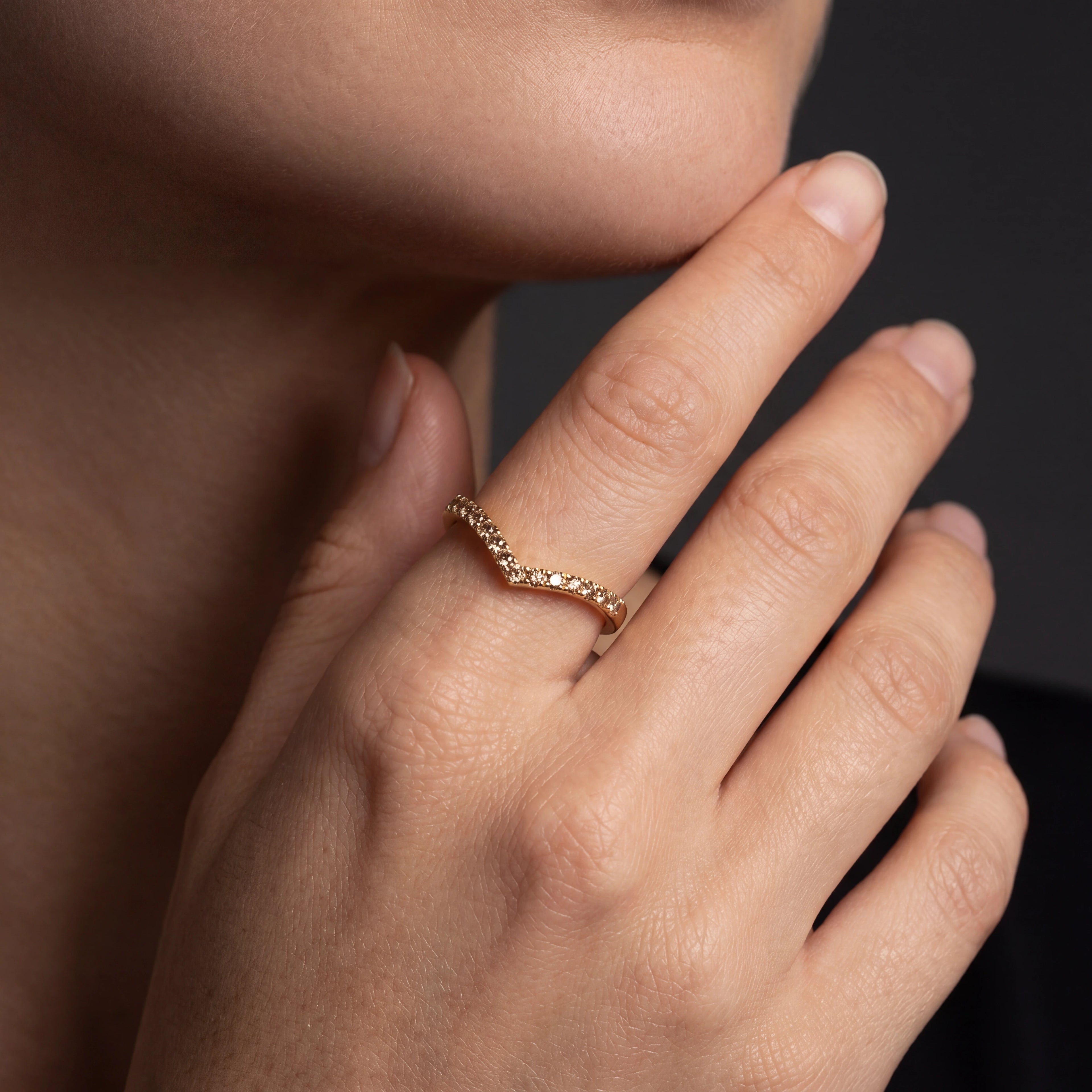 Model wearing champagne diamond wishbone ring in 14K rose gold, close-up — Brownstone Collection, Black Pearl of Queens