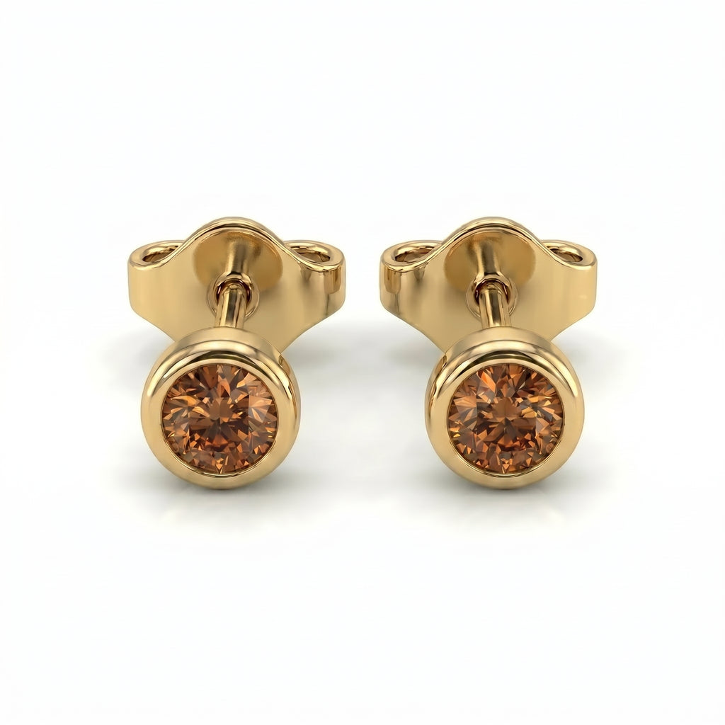 Natural cognac diamond bezel stud earrings in 14K yellow gold — pair product view on white background