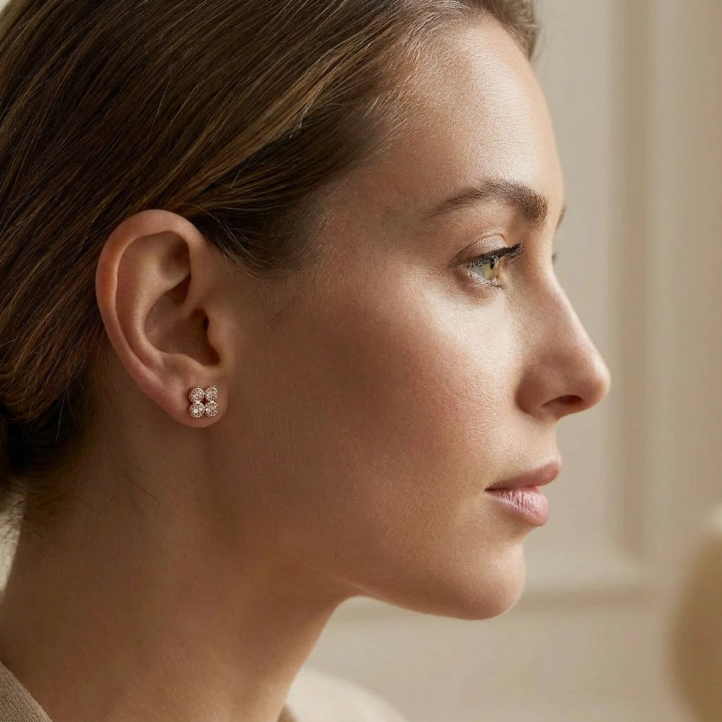 Natural cognac diamond clover stud earrings in 14K brown gold worn on ear — portrait lifestyle view, Black Pearl of Queens