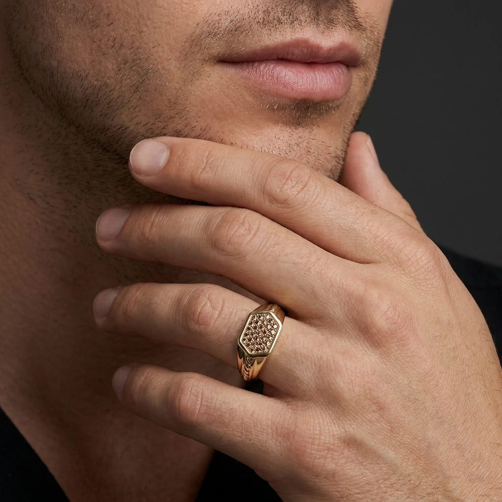 Cognac diamond pavé signet ring in 14K yellow gold worn on hand, close-up