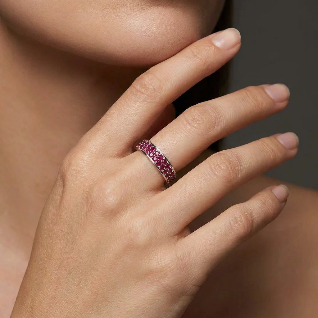 Crimson Eternity double row ruby ring worn on hand in solid 14K gold with pavé red gemstones