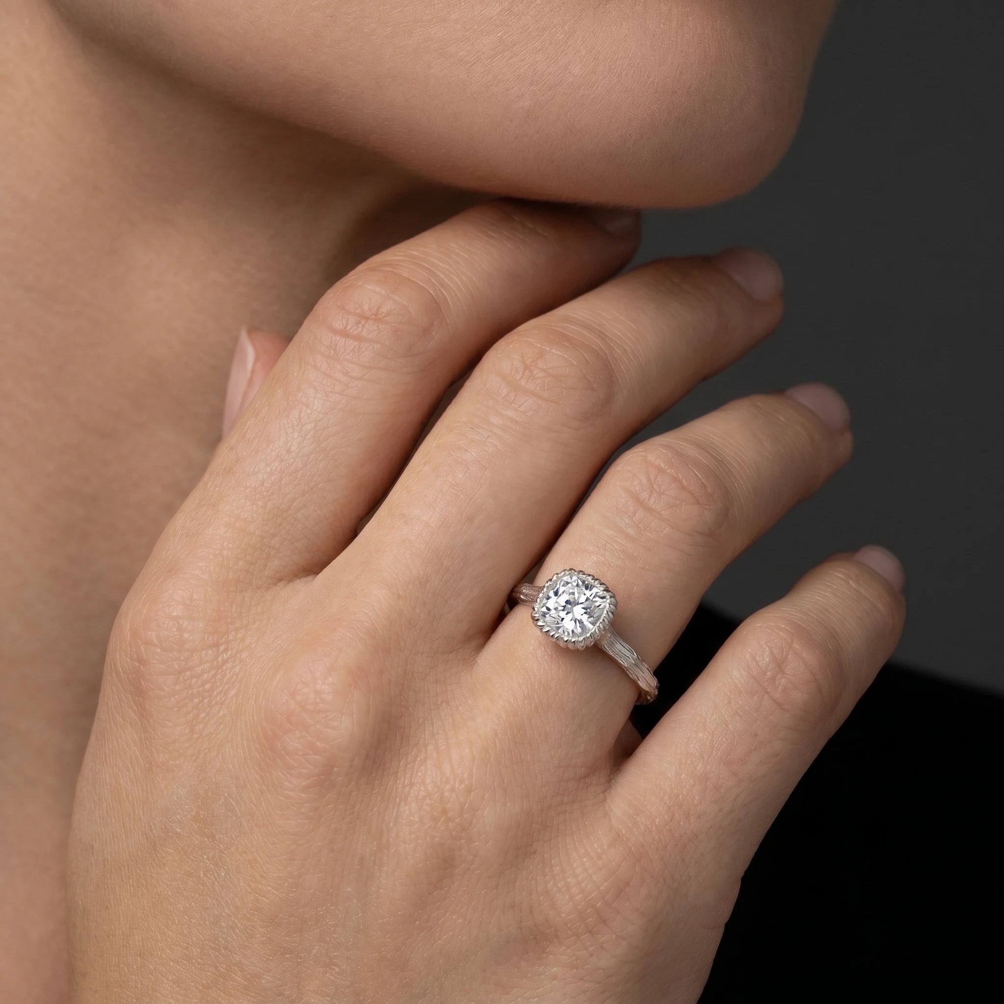 Cushion Cut Lab-Grown Diamond branch band engagement ring worn on the hand in 14K white gold
