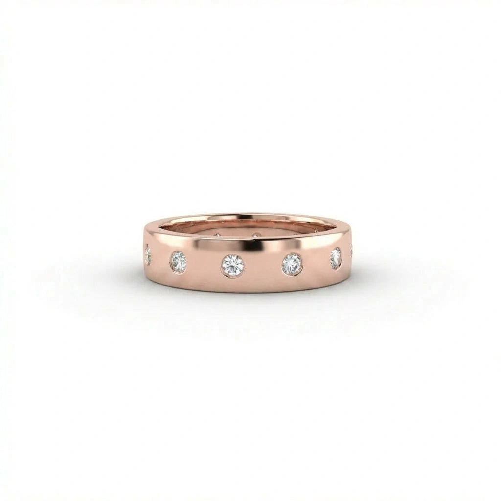 Cyrus Diamond Station Band in 14K rose gold, front view on white background showing wide domed band with 12 flush bezel-set D-F colorless lab diamonds in scattered station arrangement
