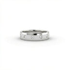 Cyrus Diamond Station Band in 14K white gold, front view on white background showing wide domed band with 12 flush bezel-set D-F colorless lab diamonds in scattered station arrangement
