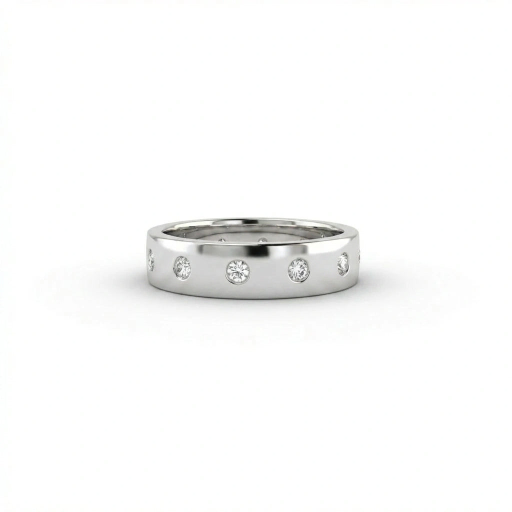Cyrus Diamond Station Band in 14K white gold, front view on white background showing wide domed band with 12 flush bezel-set D-F colorless lab diamonds in scattered station arrangement