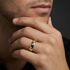 Male model wearing Cyrus Diamond Station Band in 14K yellow gold, close-up editorial portrait showing wide domed band with 12 flush bezel-set D-F colorless lab diamonds scattered around circumference
