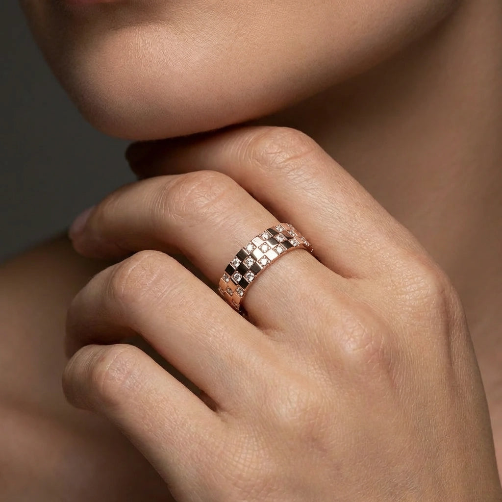 Cyrus Tessera diamond band worn on hand in 14K rose gold featuring mosaic square pattern with flush set diamonds