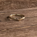 D initial ring solid 14K gold version on wood surface showing curved band and polish – Black Pearl of Queens
