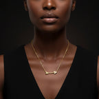 Luxury portrait of model wearing 14K gold diamond arrow necklace against dark background