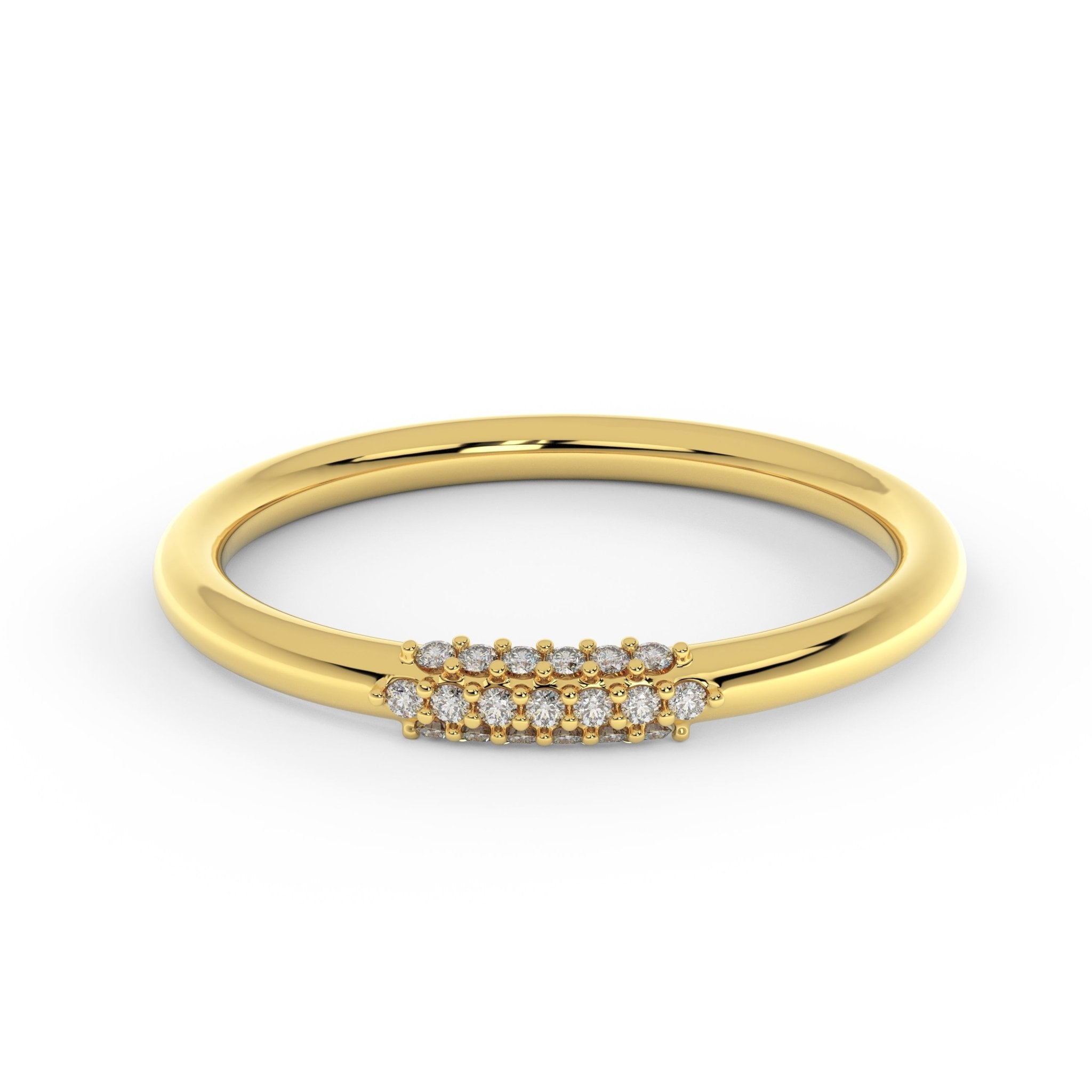 Diamond wire ring in 14K yellow gold with petite cluster of diamonds, slim 2mm wire wedding ring close-up on white surface
