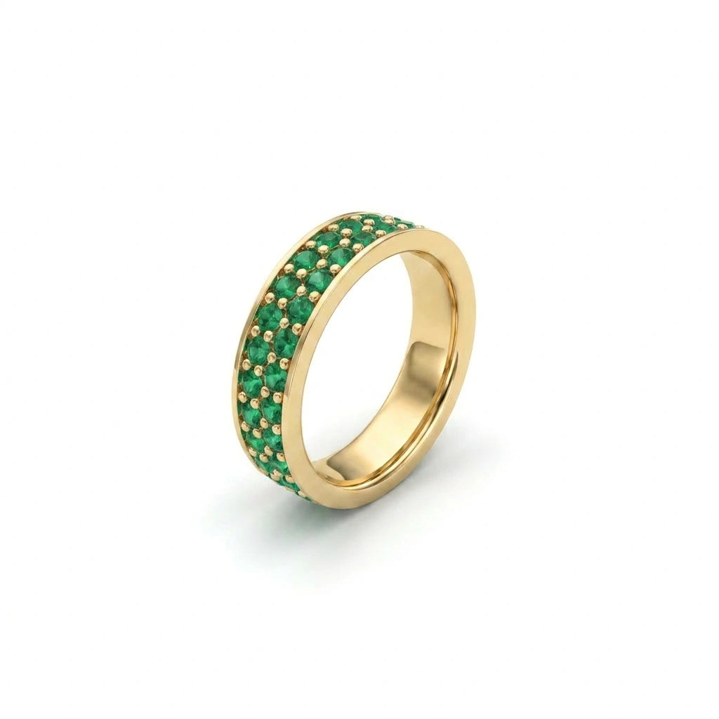 Angled view of double row emerald eternity ring in 14K yellow gold with pavé set emerald stones