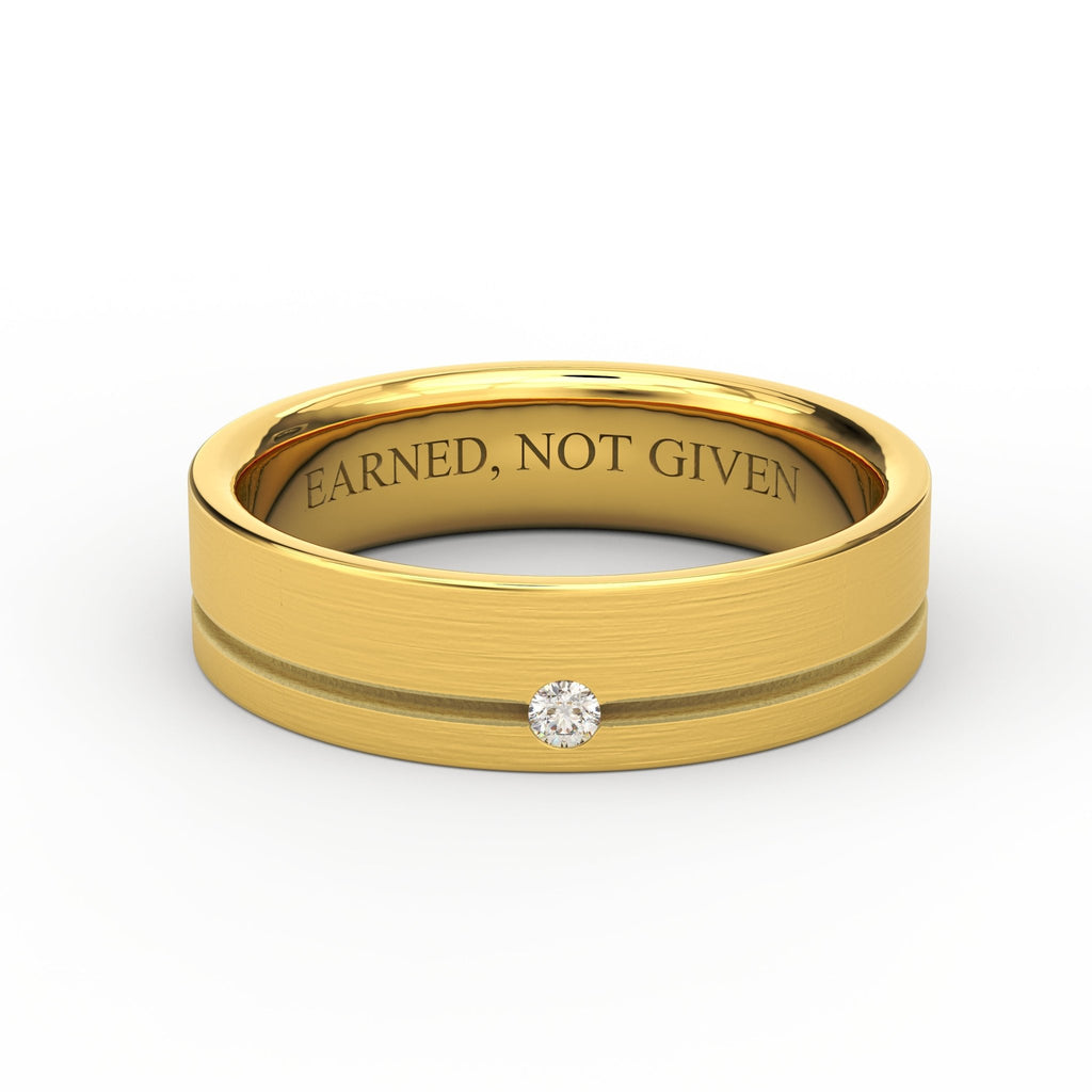 Men’s 5.5mm 14K gold wedding band with single round diamond and brushed finish, engraved “Earned, Not Given”