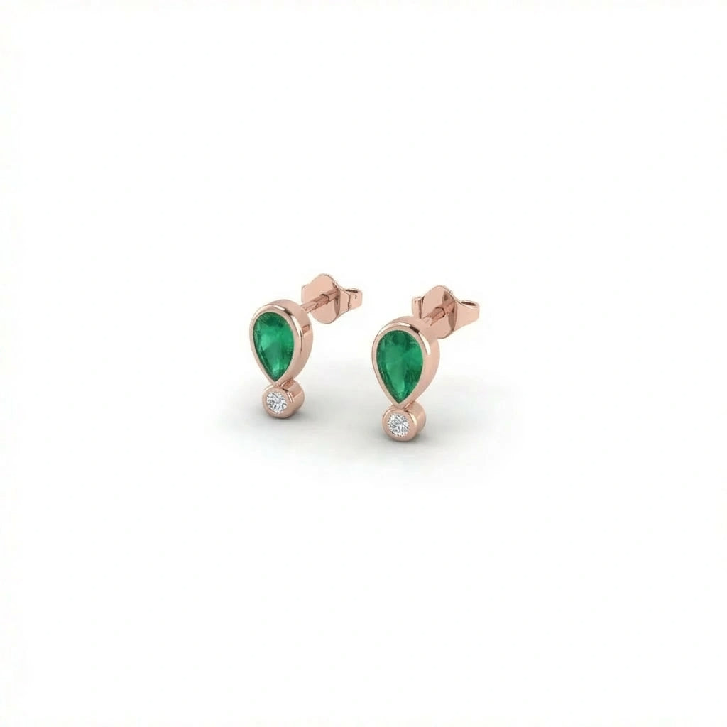 Elyra emerald drop stud earrings in solid rose gold with pear shaped emerald and small round diamond drop
