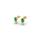 Elyra emerald drop stud earrings in solid yellow gold with pear cut emerald and bezel set diamond accent