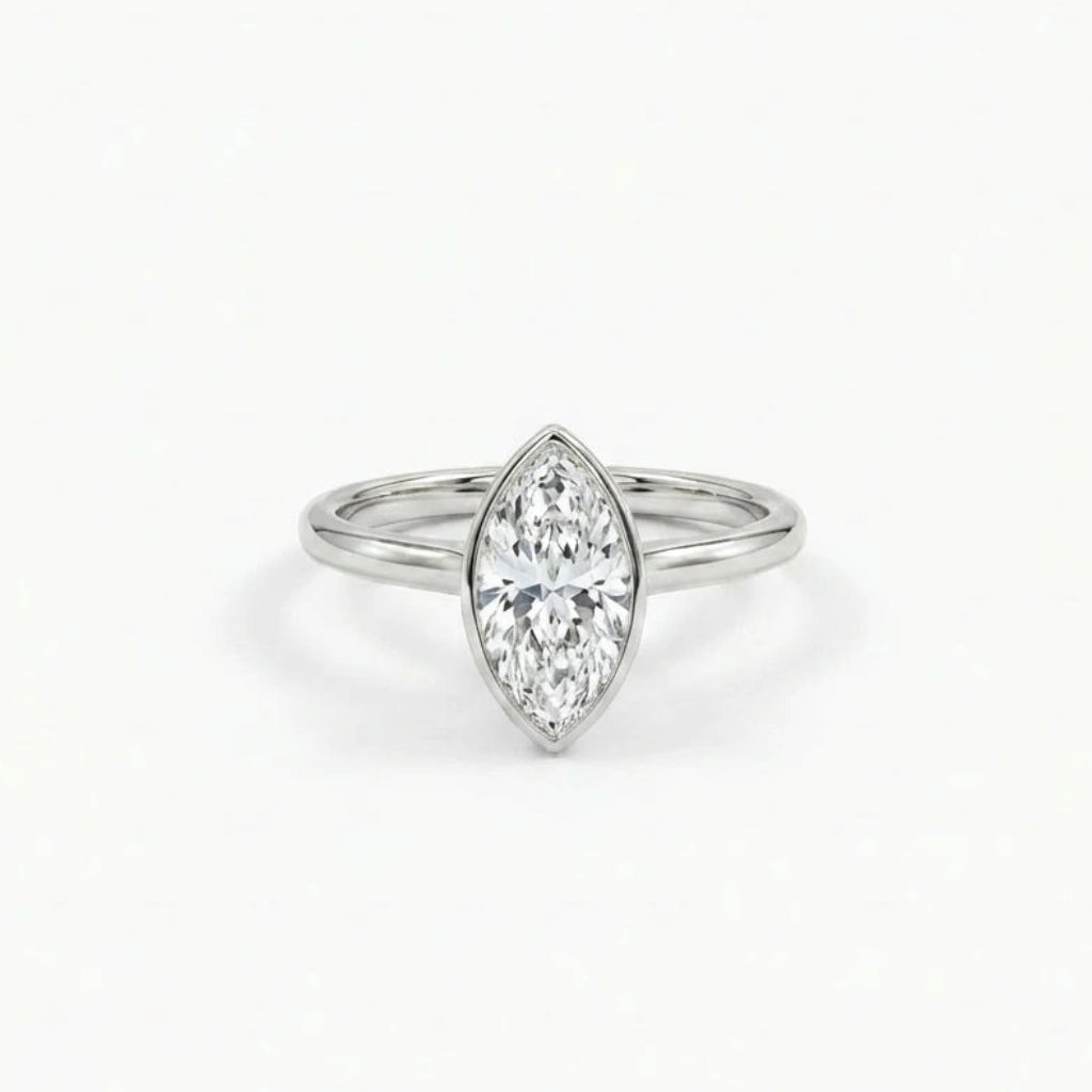 Solid 14K white gold marquise cut diamond ring with smooth bezel setting and minimalist band