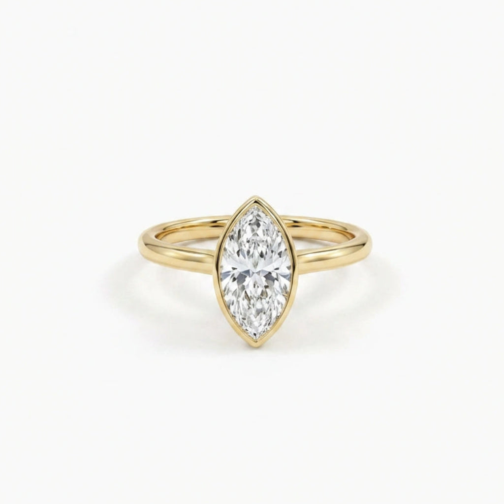 Solid 14K yellow gold marquise cut diamond ring with bezel setting and slim polished band