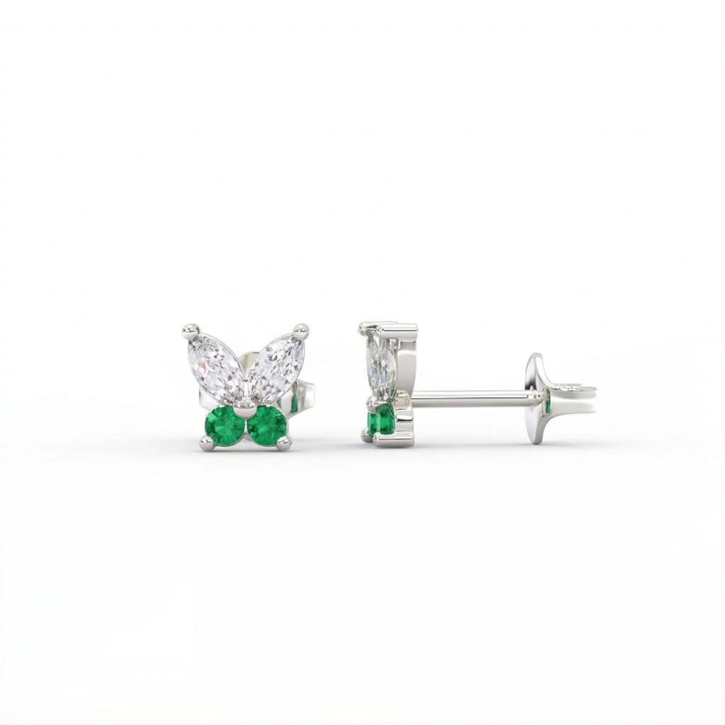 Butterfly stud earrings featuring marquise diamonds and emerald gemstones in solid white gold, front and side view.