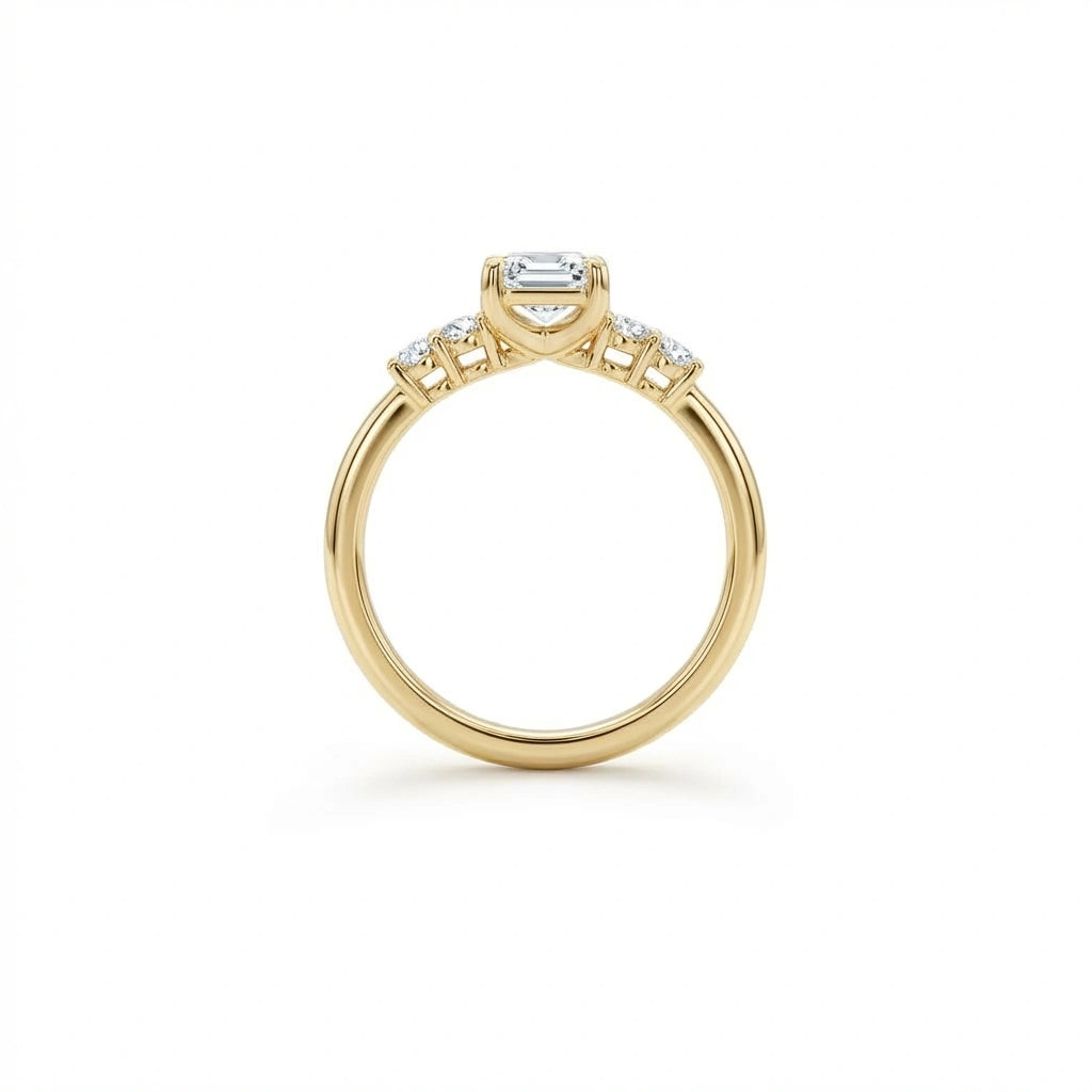 Side profile of emerald cut five-stone engagement ring showing setting height and individually prong-set side stones