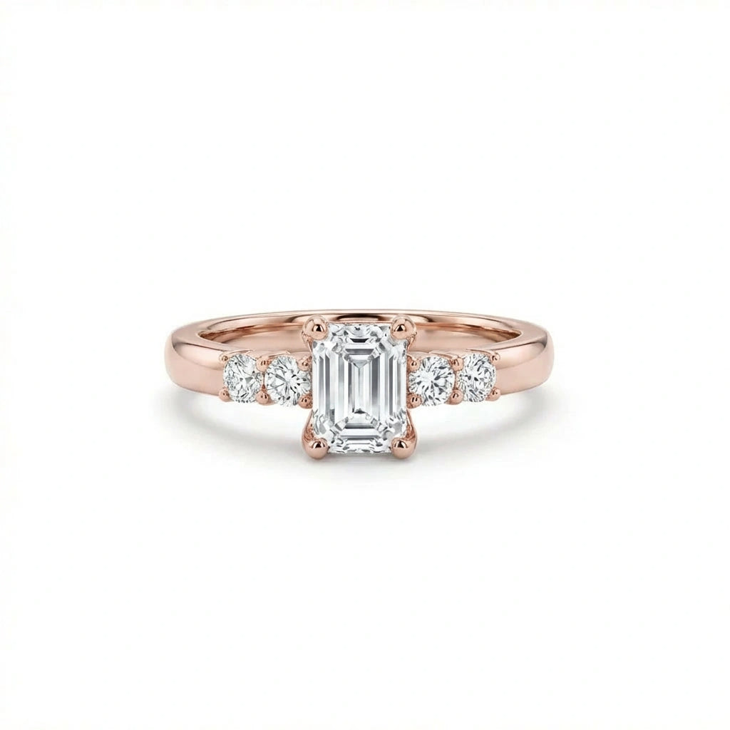 Emerald cut five-stone engagement ring in 14K rose gold, front view with four graduated round side stones